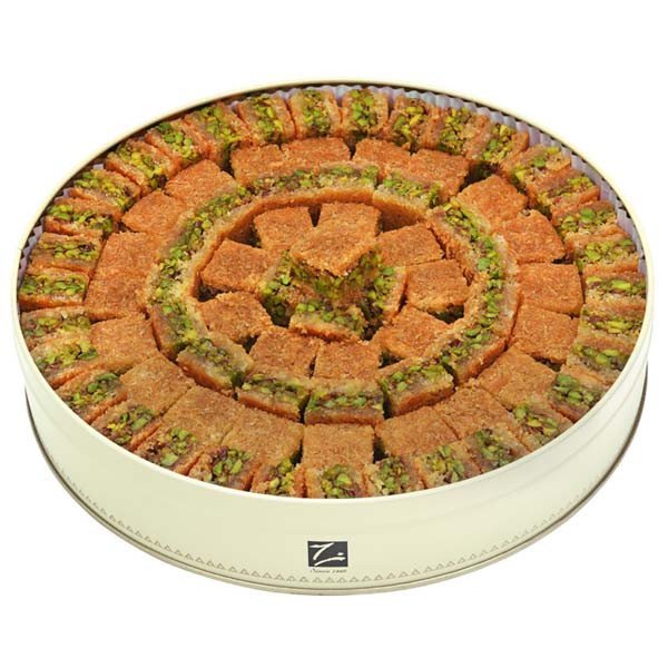 Nabulsieh with pistachios – shredded kenafeh squares in a round tin, crafted by Zalatimo Brothers